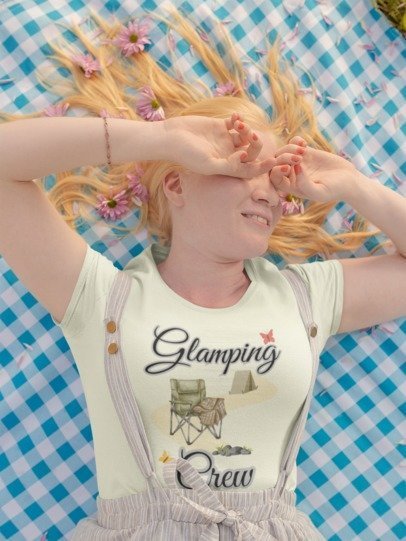 Person wearing a 'Glamping Crew' shirt with a checkered background