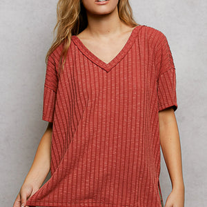 Red textured dress worn by a person on a gray background