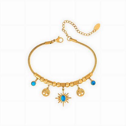Gold bracelet with charms on a white background