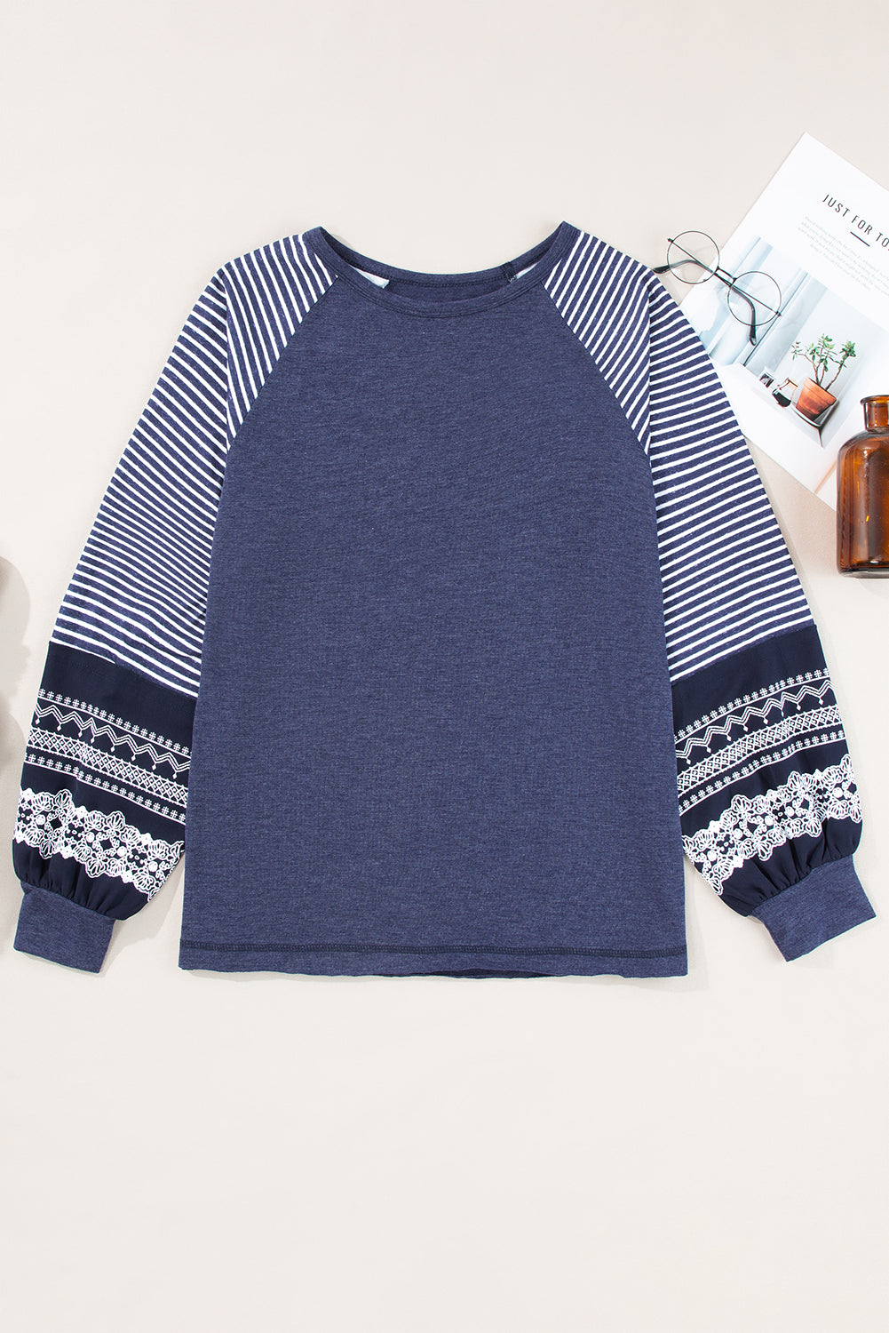 Blue sweatshirt with striped sleeves on a white background
