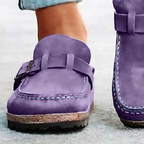Purple suede shoes with cork soles on a light background