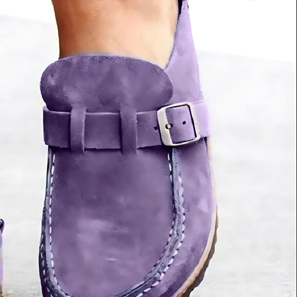 Close-up of a purple shoe with a buckle on a white background