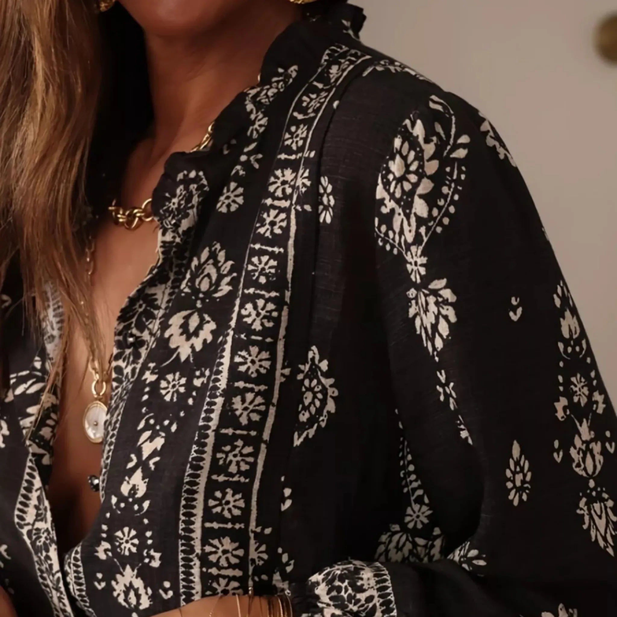 Black and white patterned blouse with a blurred background