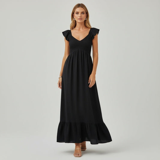 Woman wearing a black dress on a gray background