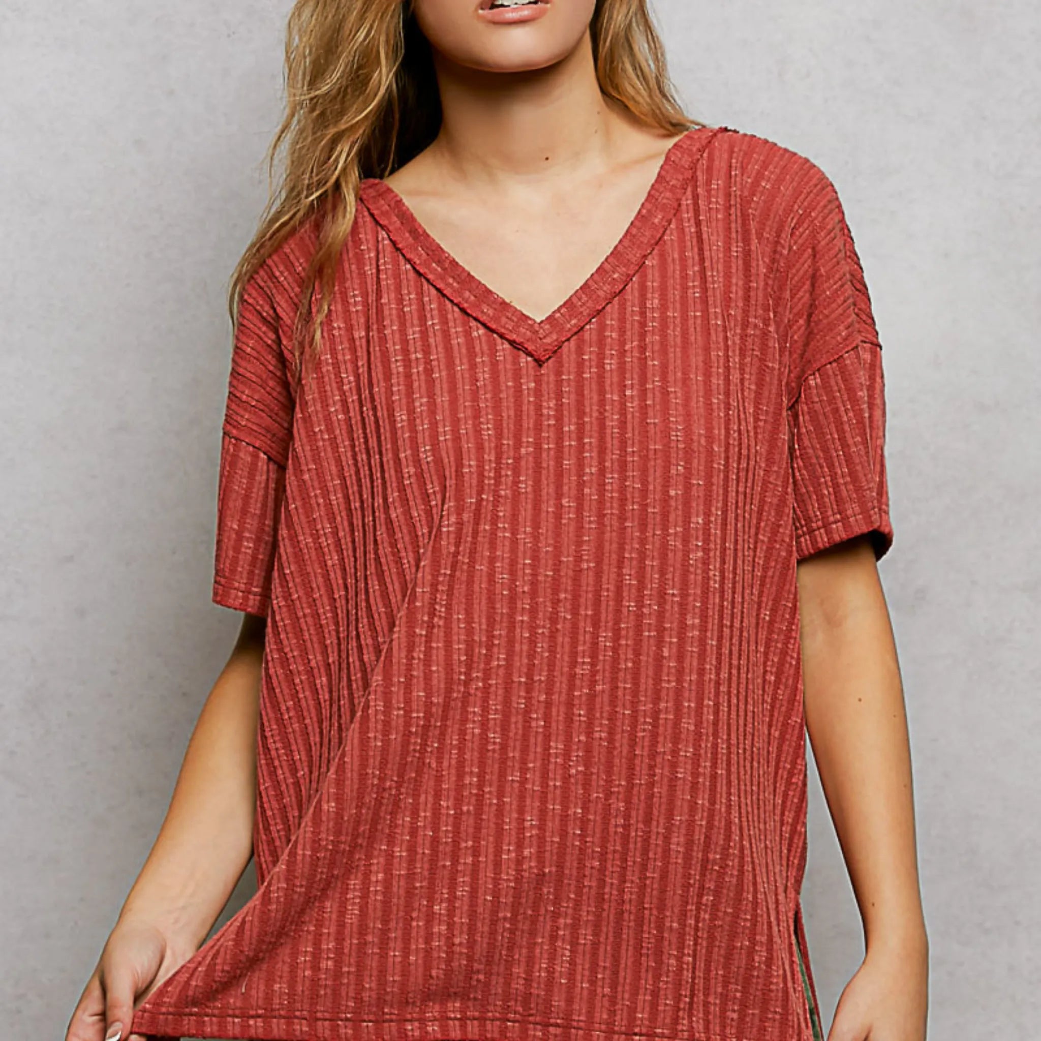 Red textured dress worn by a person on a gray background